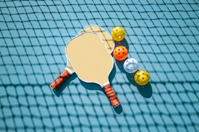 Pickleball equipment on the ground.