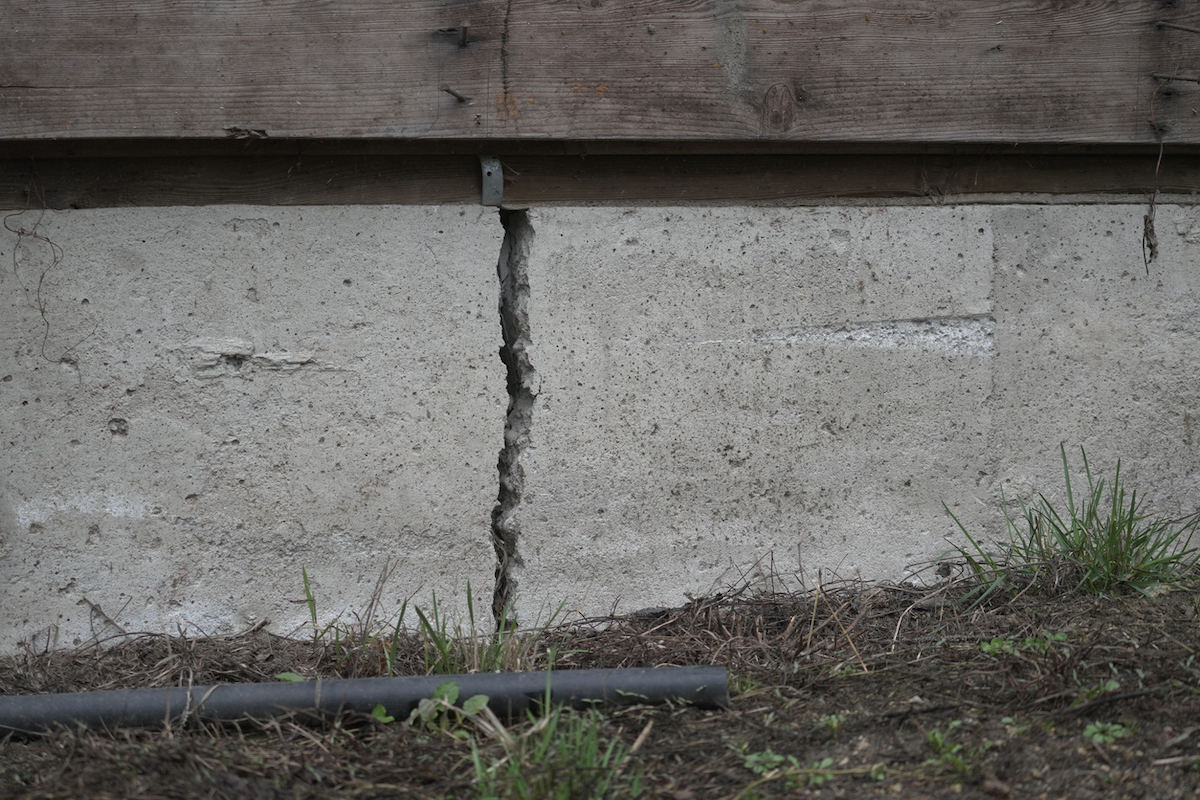 A house's concrete foundation is cracked.