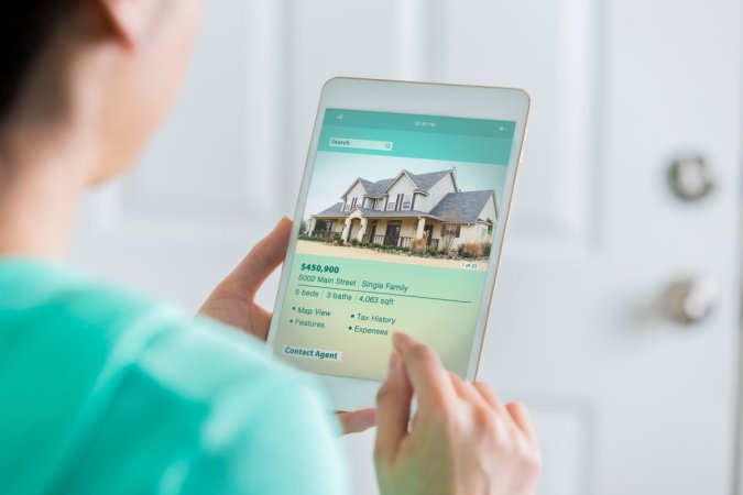 A woman is shopping for a new home on her tablet.