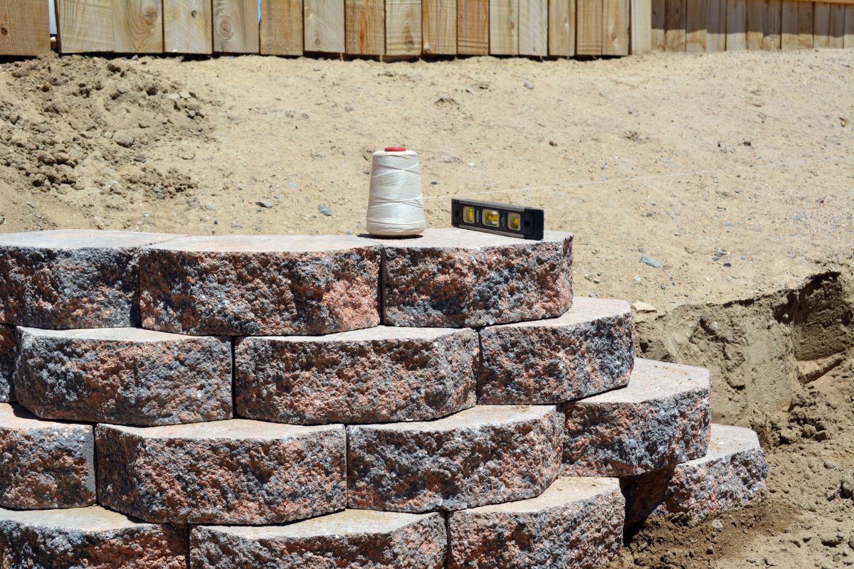 A railroad tie retaining wall under construction.