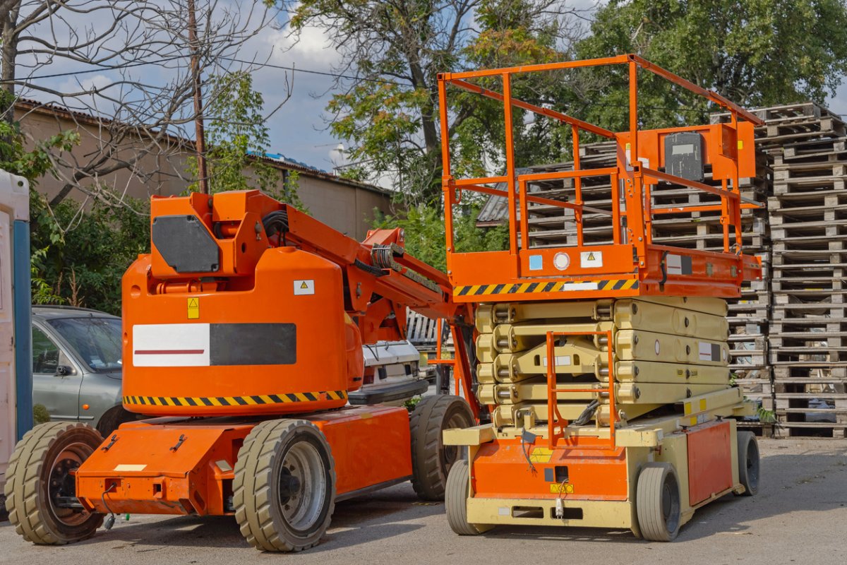 A view of an orange scissor lift.