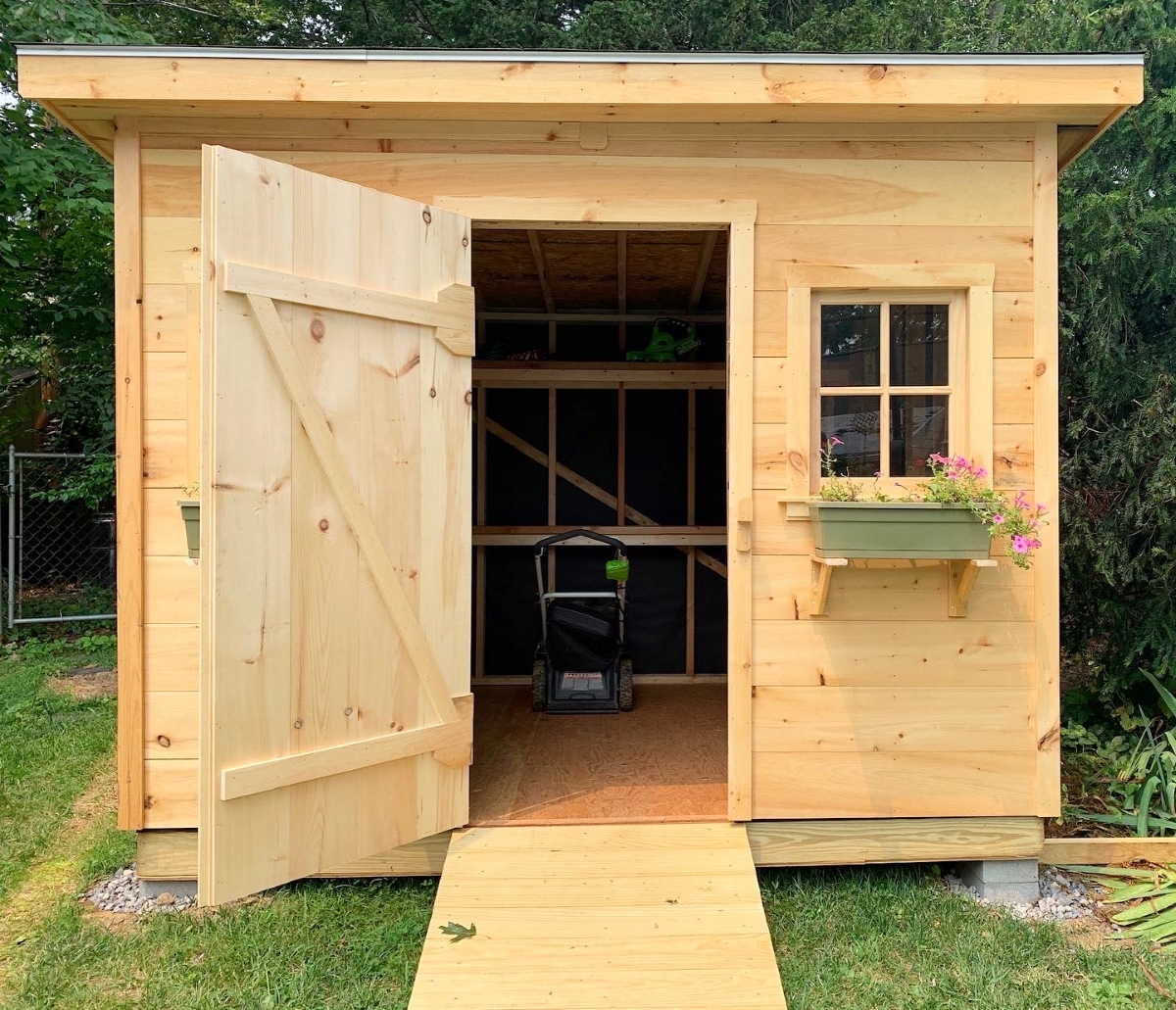 A newly built wooden shed in the backyard.