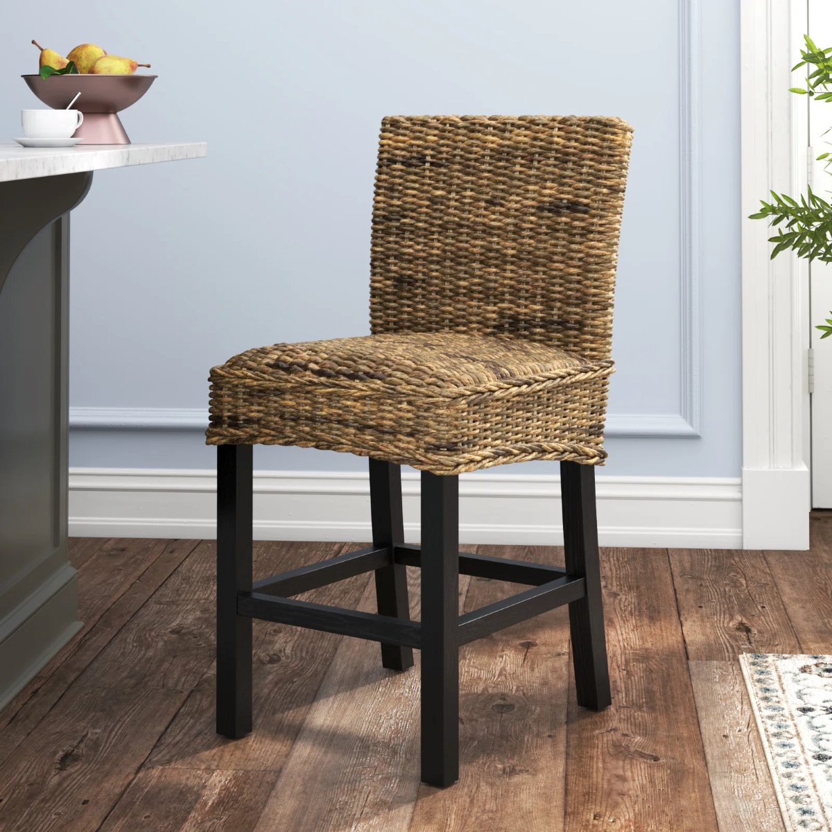 A kitchen island stool with wicker rattan seat.