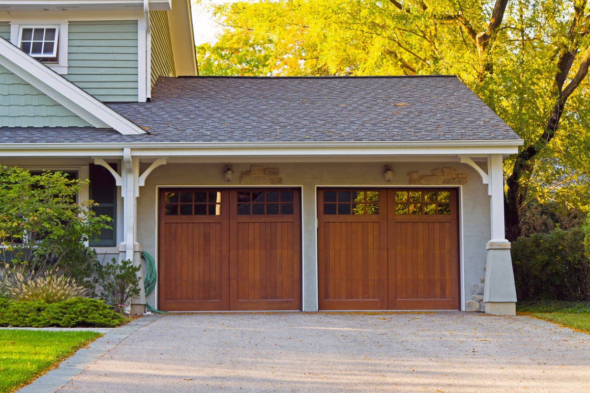 A close up of a 2-car garage with wooden doors. 