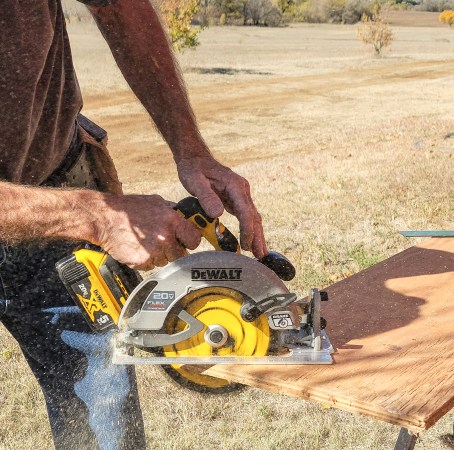 Man using dewalt circular saw to cut wood