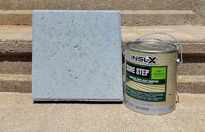 A gallon can of Benjamin Moore INSL-X paint next to a cement block during testing.