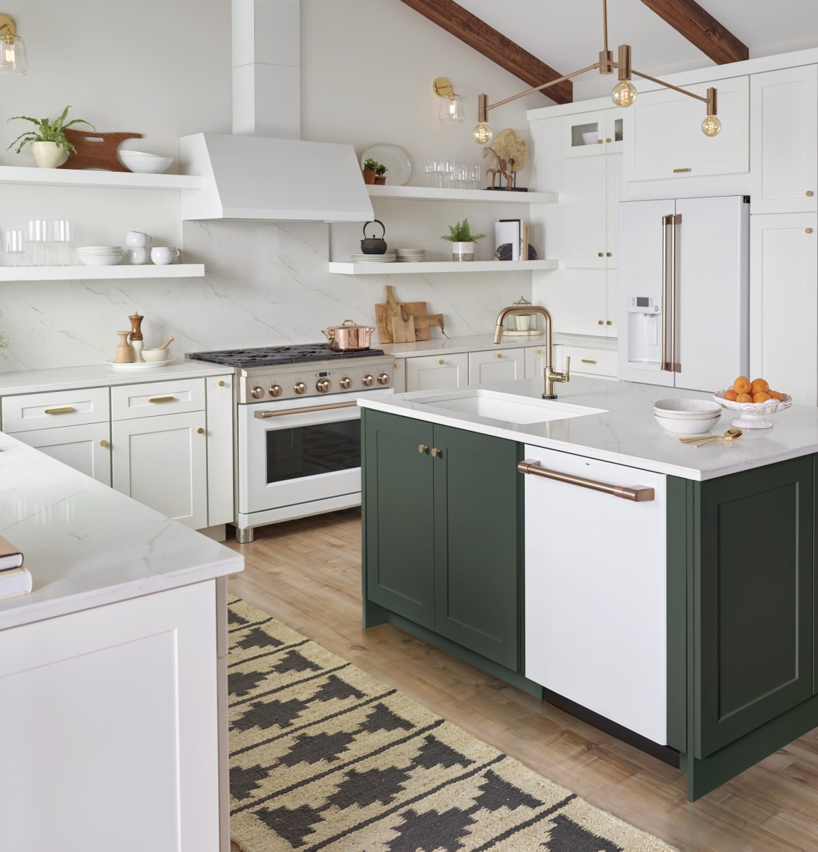 A matte white dishwasher and range match a white and forest green kitchen.