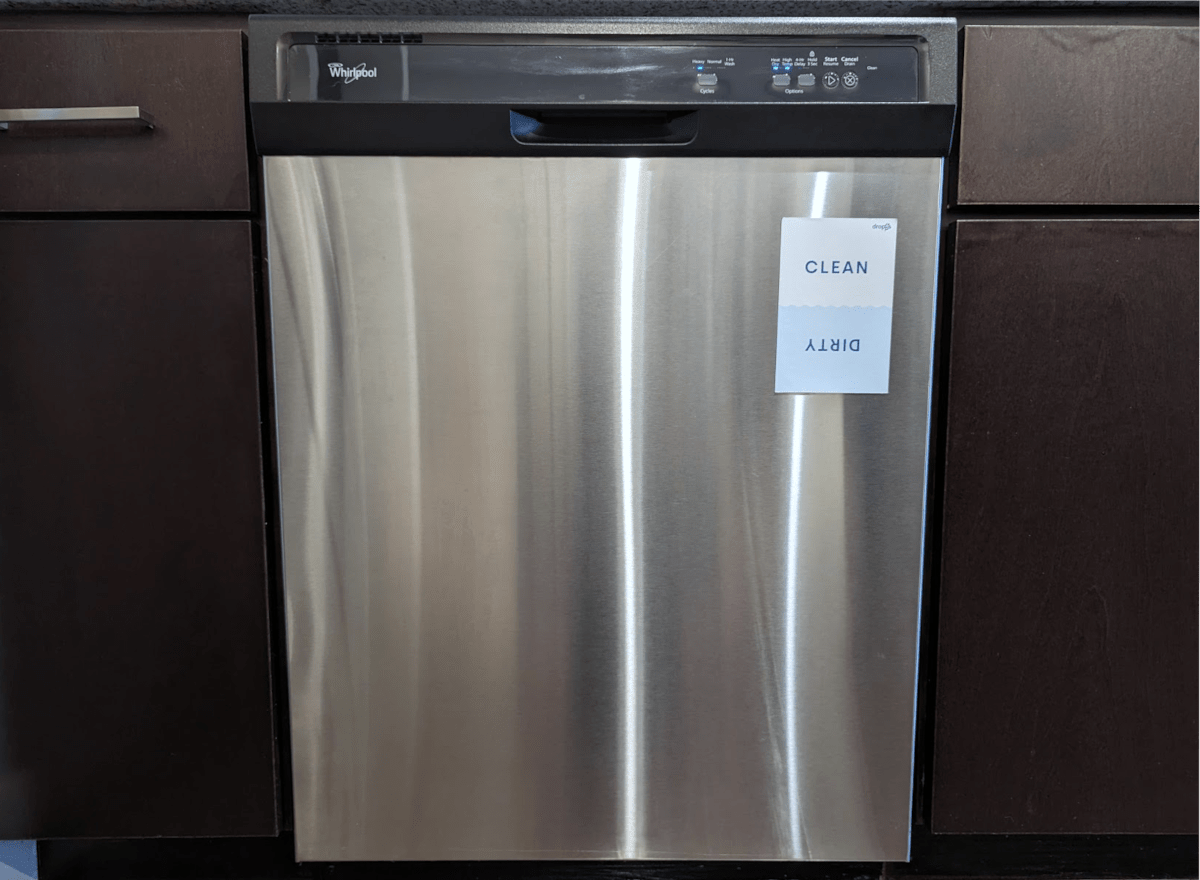 A stainless steel dishwasher with a Dropps magnet on its face reading "Clean" when right-side up and "Dirty" when flipped upside down.