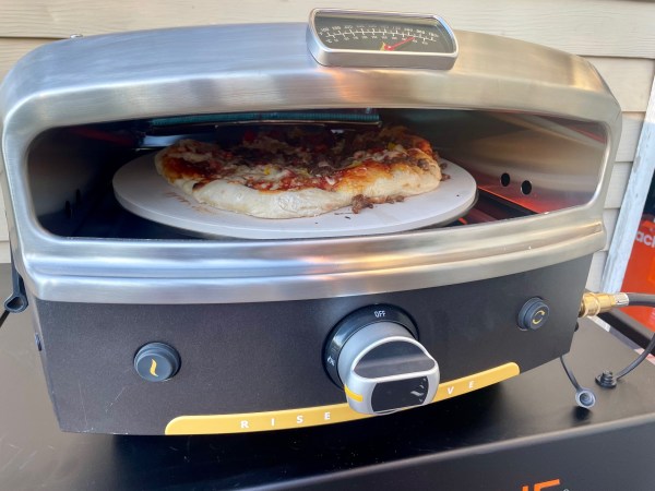 A homemade pizza oven cooking in the Halo outdoor pizza oven.