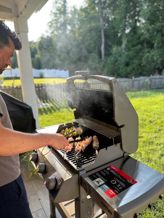 Person grilling food on the Weber Spirit II E-310