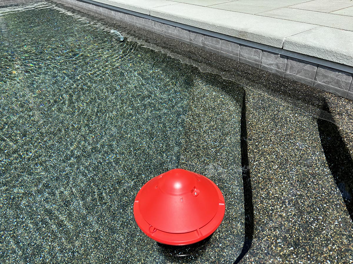 The Lifebuoy BCone floating alarm in a pool during hands-on testing.