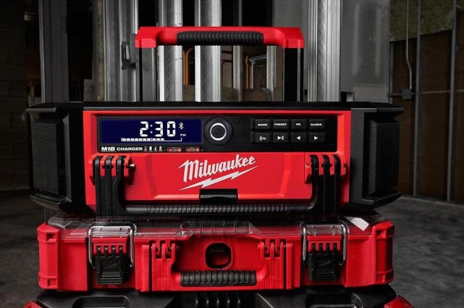 The Milwaukee M18 Packout Radio and Charger at a building site.