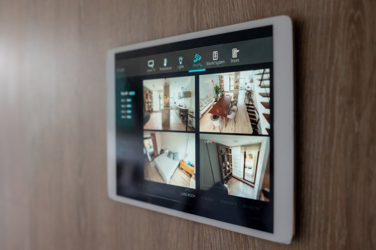 A close up of a smart home hub showing a home security system feed. 