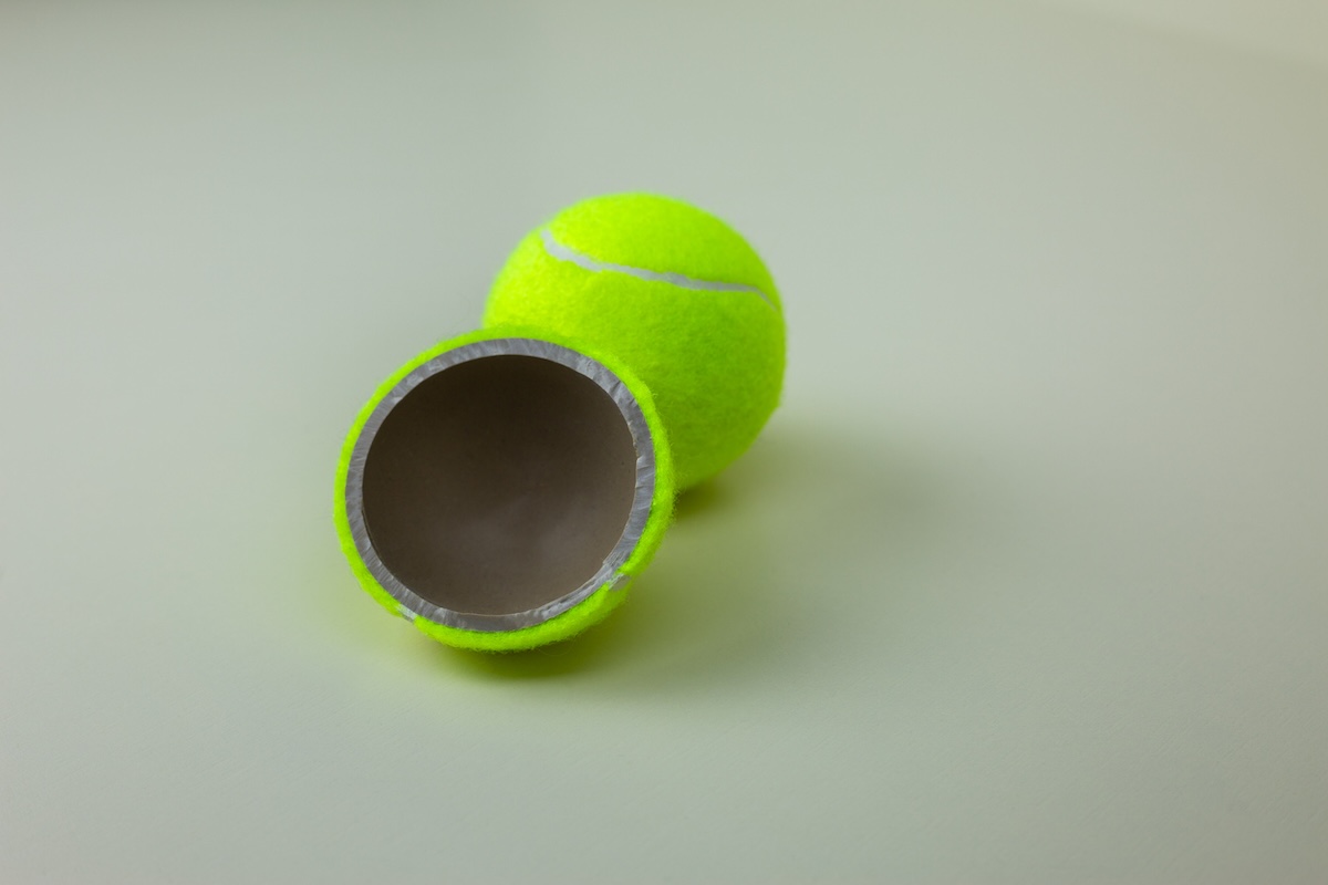 Tennis ball cut in half to be used as a hiding spot.