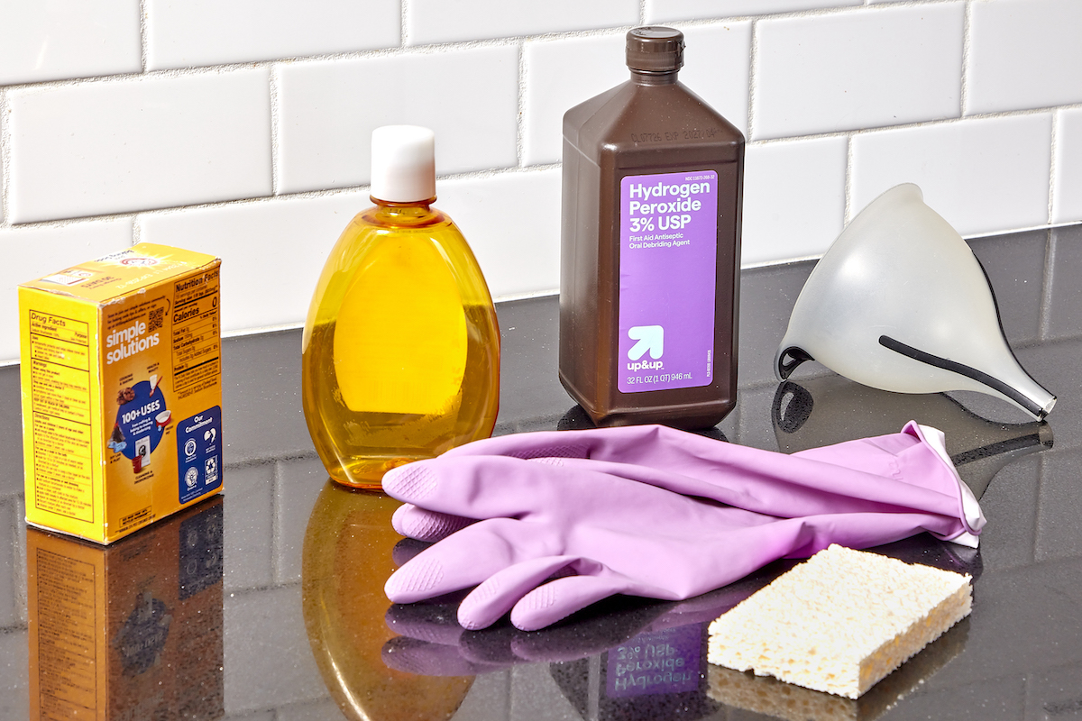 Materials and tools needed to create homemade grout cleaner.