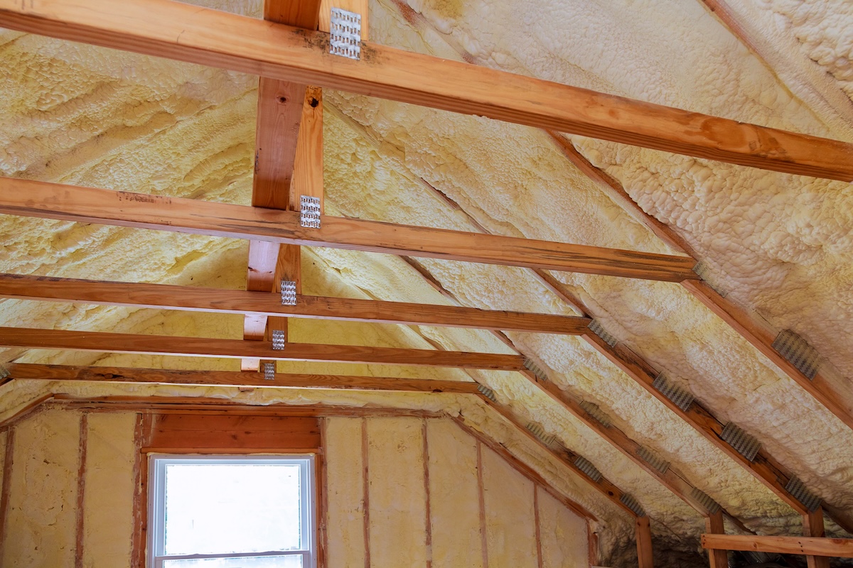 Spray foam insulation installed in a home attic for energy efficiency.