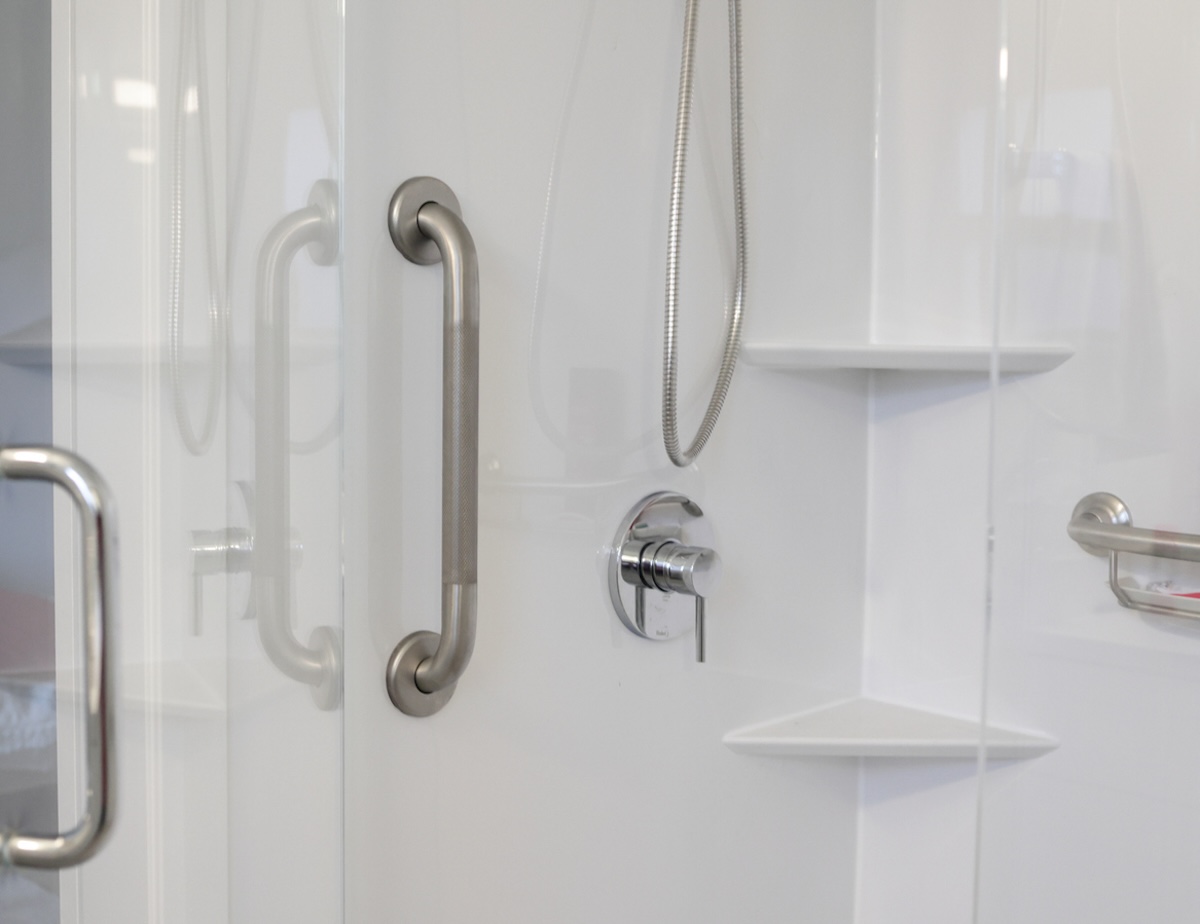 A metal grab bar installed in a home shower to improve safety and support universal design.