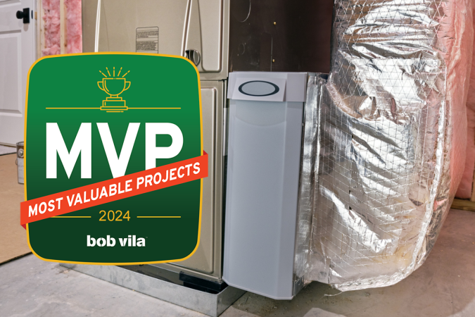 A whole-house air cleaner installed in a residential basement with a graphic overlay that says Bob Vila's 2024 MVPs.