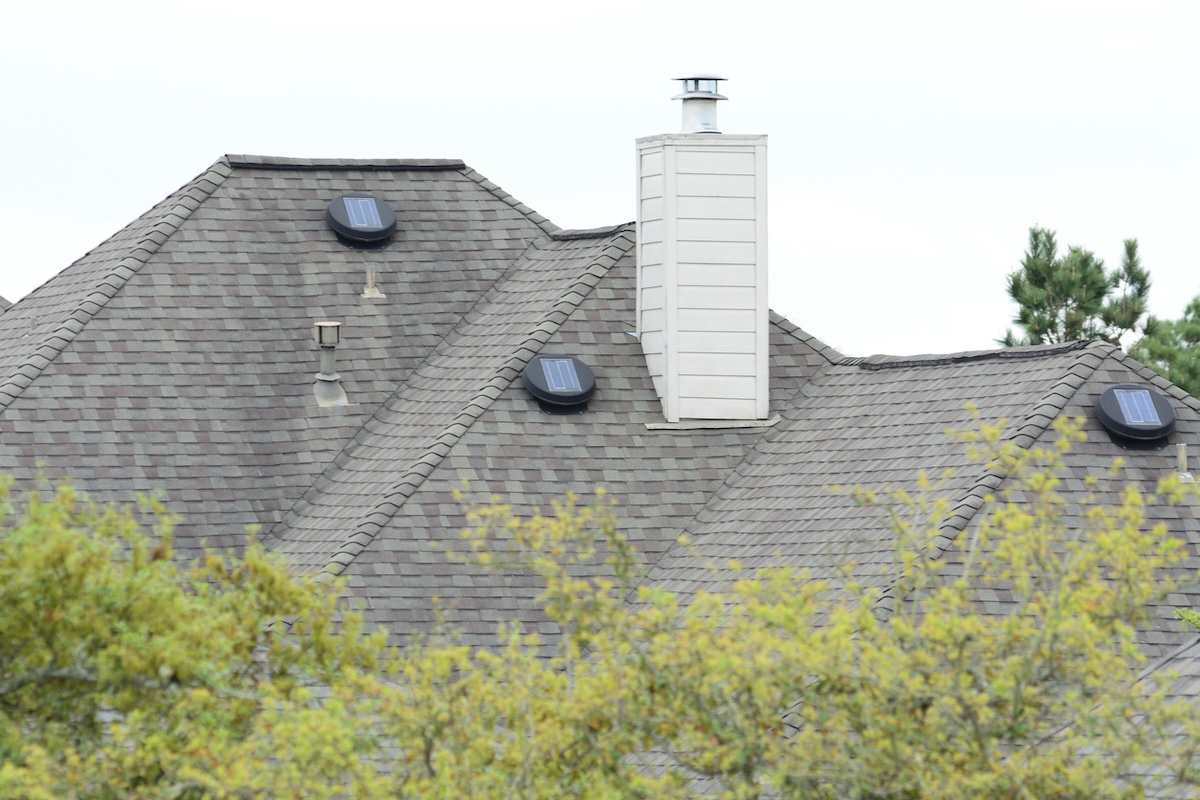 Solar-powered attic fans installed on the roof of a home.