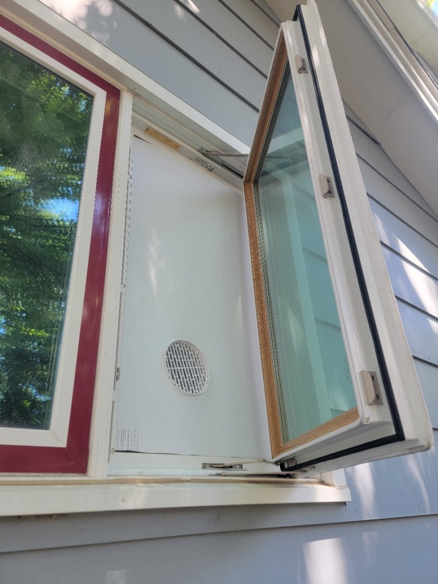 A portable AC unit vented in a casement or crank window.