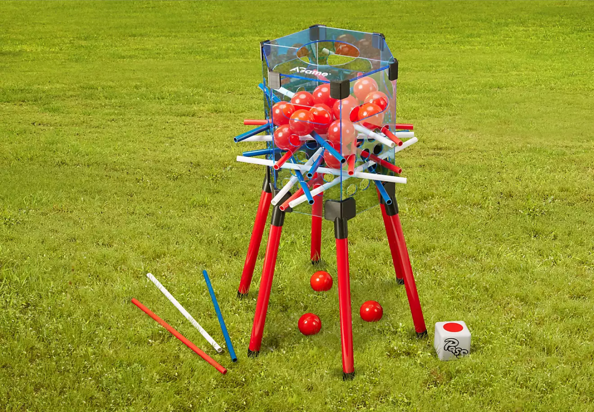 An oversized pull and plunk game sits on the grass.