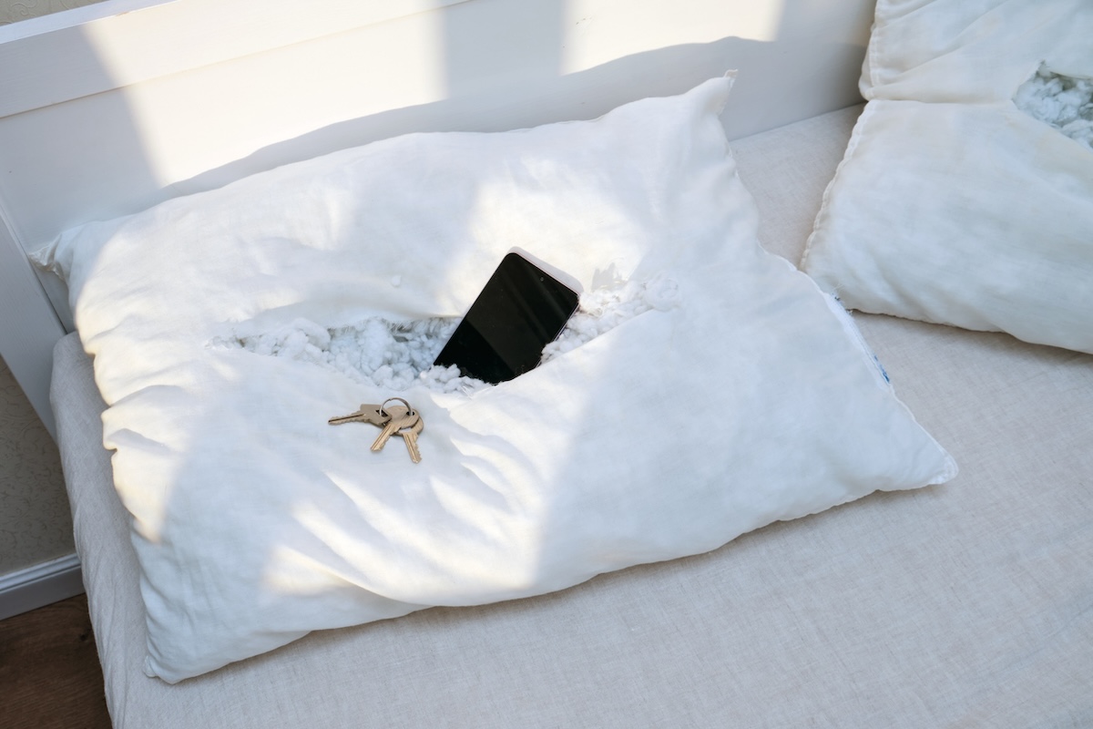 Hiding cash, cell phone, and keys in a white pillowcase.