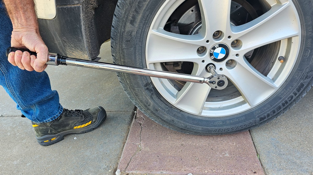 A person using the CDI Torque Products ½" 30-250 ft-lbs Torque Wrench on a car tire during testing.