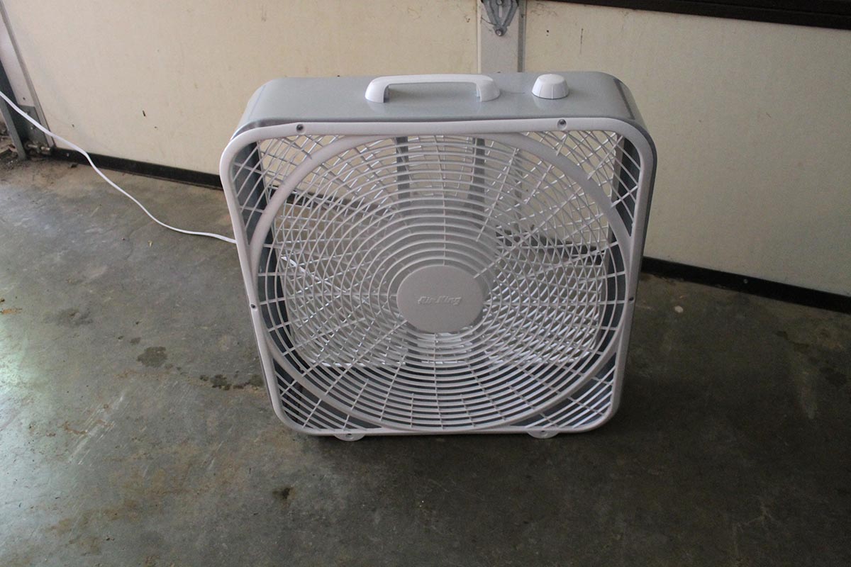 White Air King Commercial-Grade Box Fan plugged in and running