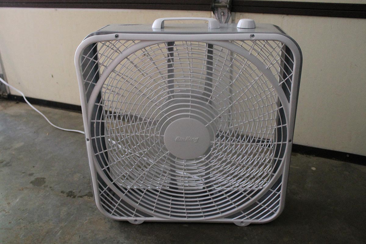 Air King Commercial-Grade Box Fan on concrete garage floor 