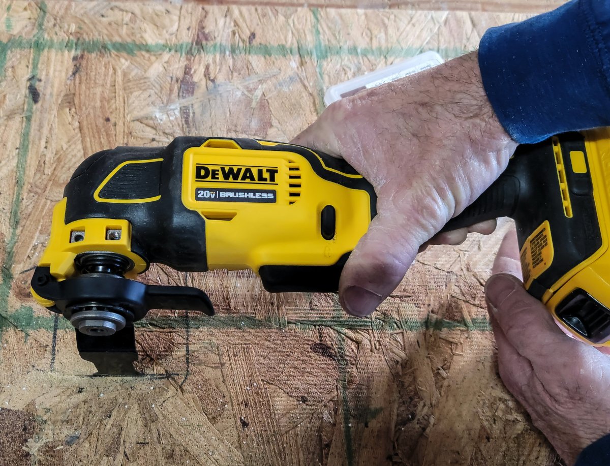 DeWalt 20V Oscillating Multi-Tool cutting through a sheet of OSB