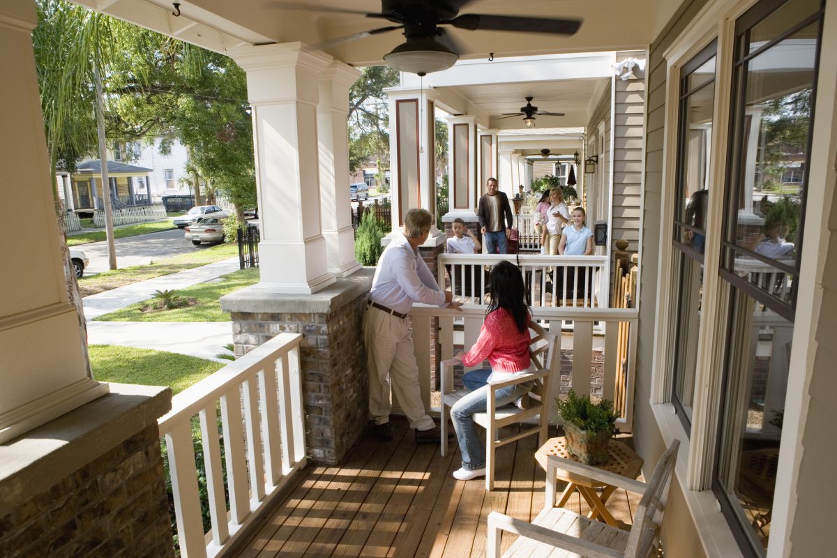 Neighbors on their front porches talking.