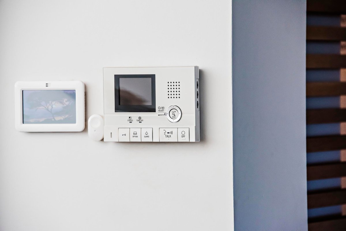 A close up of a home security hub mounted on a wall. 