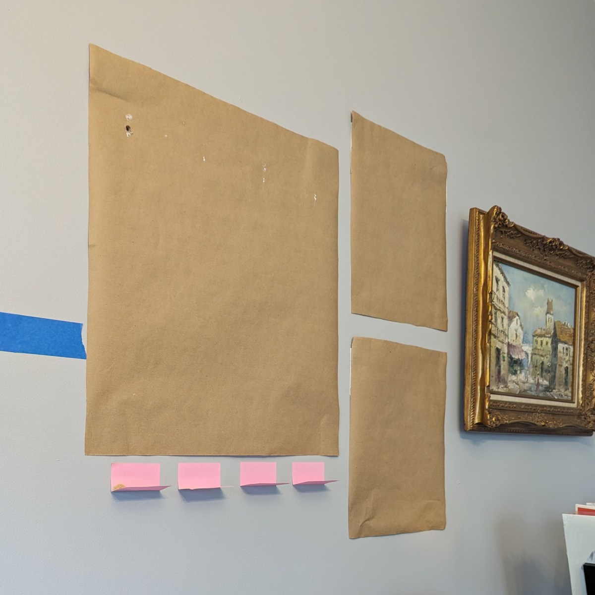 This picture-hanging hack uses sticky notes to collect drywall dust