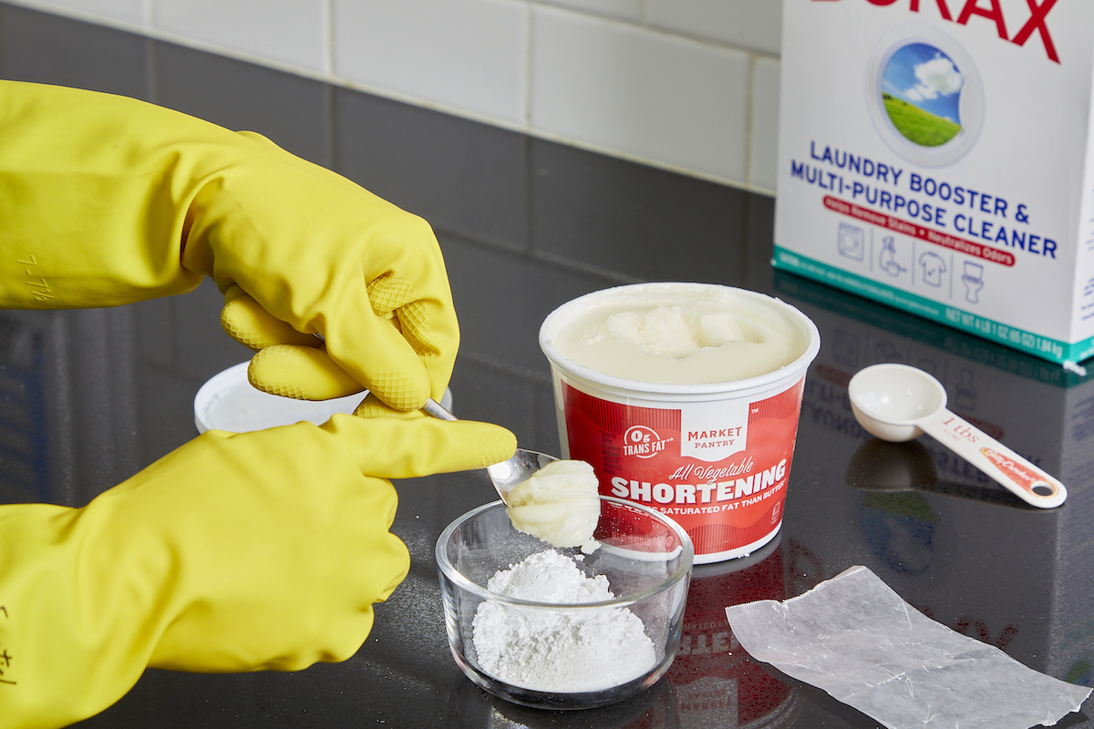 Woman mixes shortening, powdered sugar, and borax for an ant repellent.