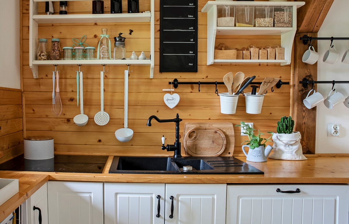 A kitchen with wooden paneling background.