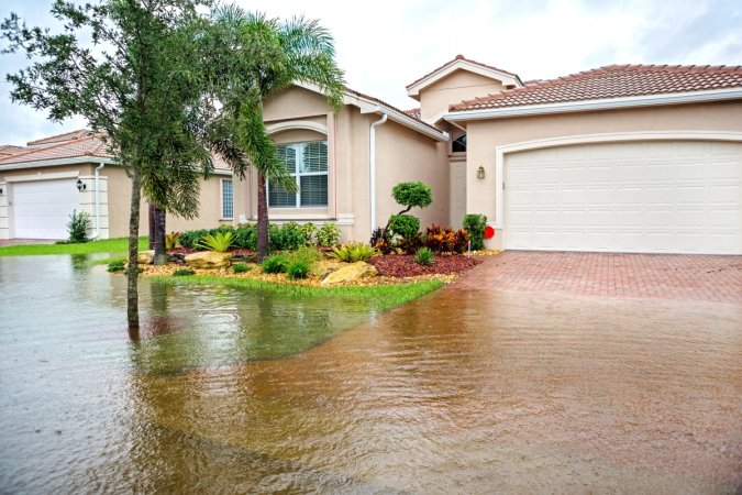 A home's front yard is flooded by severe weather.