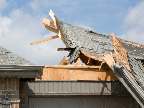 House roof damaged during tornado winds.