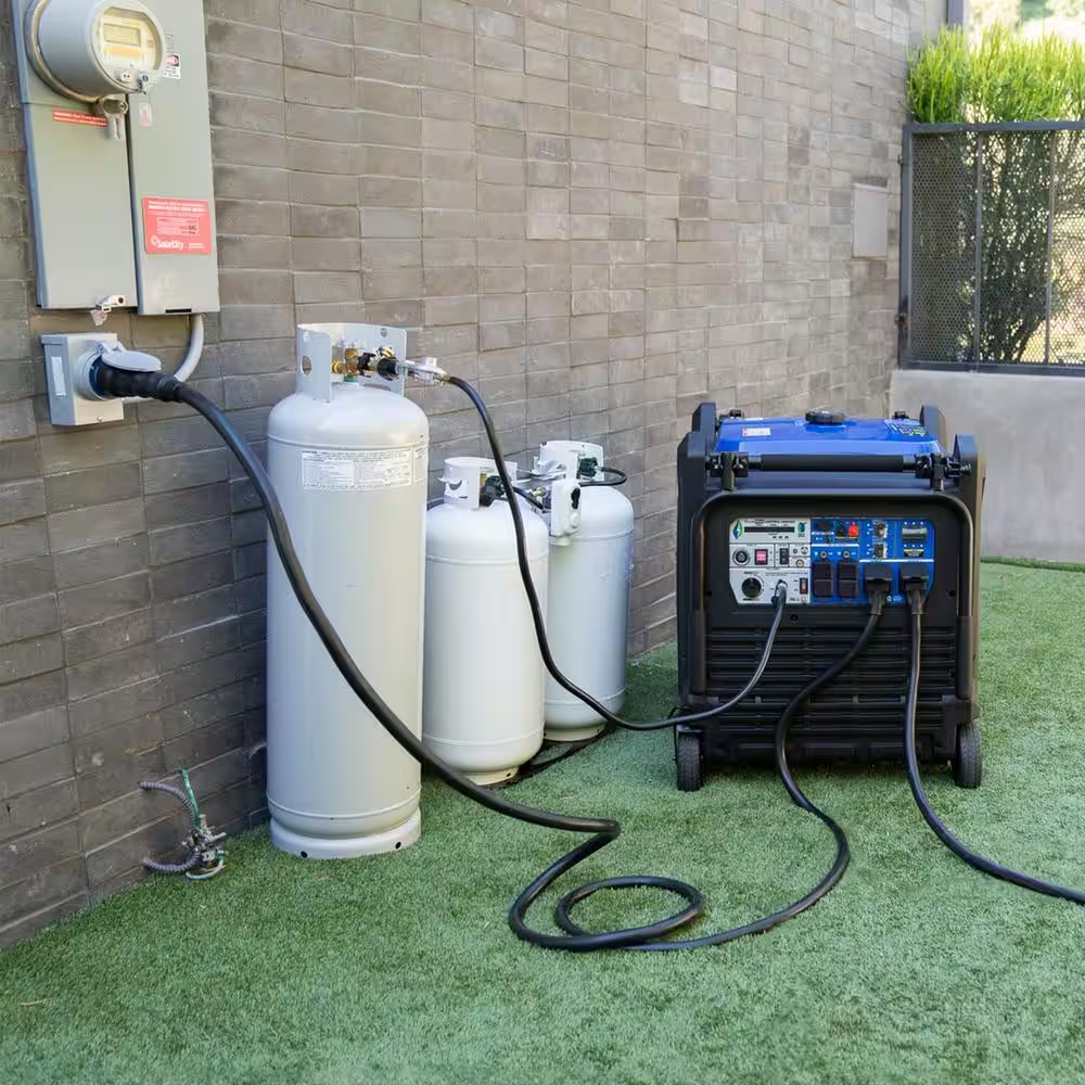 A 16,000-watt DuroMax portable inverter generator is connected to a series of propane tanks and plugged into a house for power.