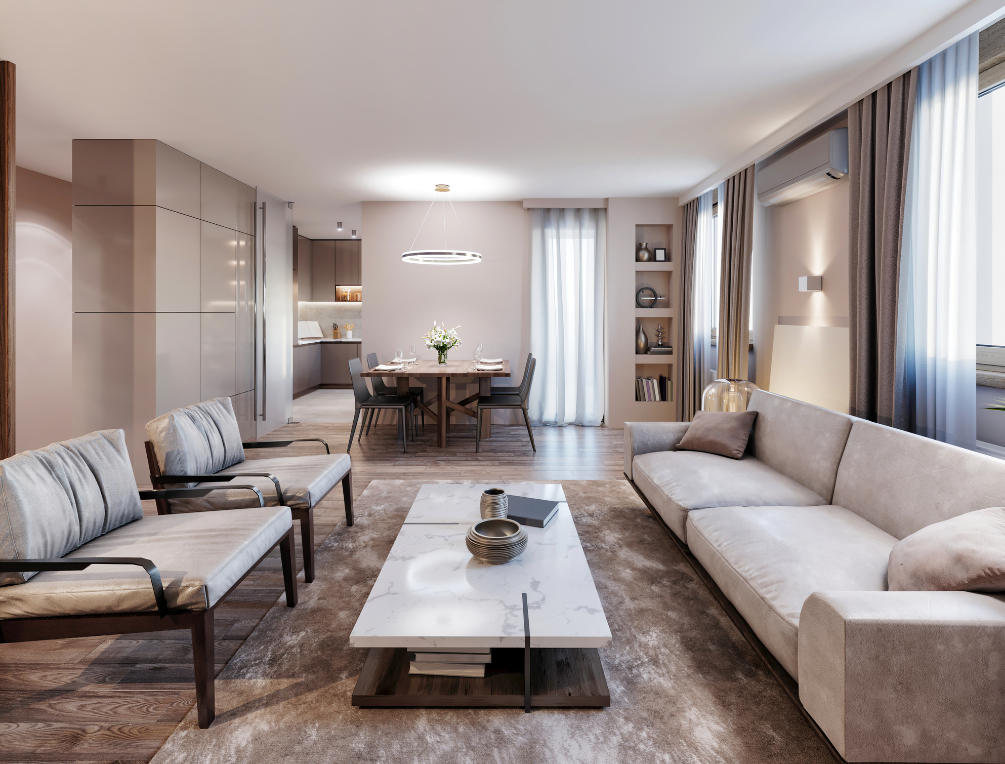 A modern living room furnished with a long cream suede couch, two matching accent chairs, and a long marble coffee table.