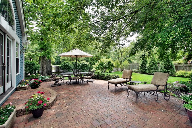 Brick patio with table umbrella and chairs