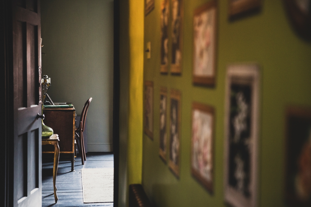 A view into a room through a corridor.