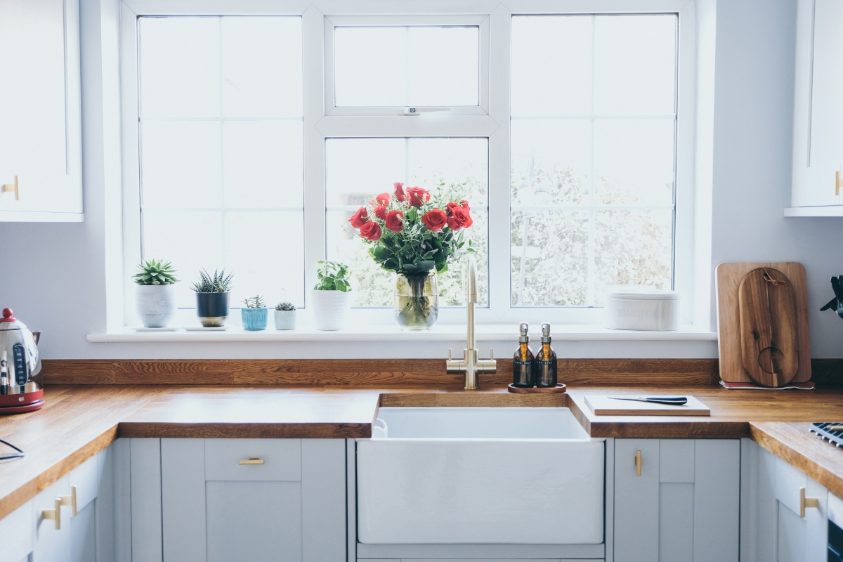 A bright kitchen with wooden counters.