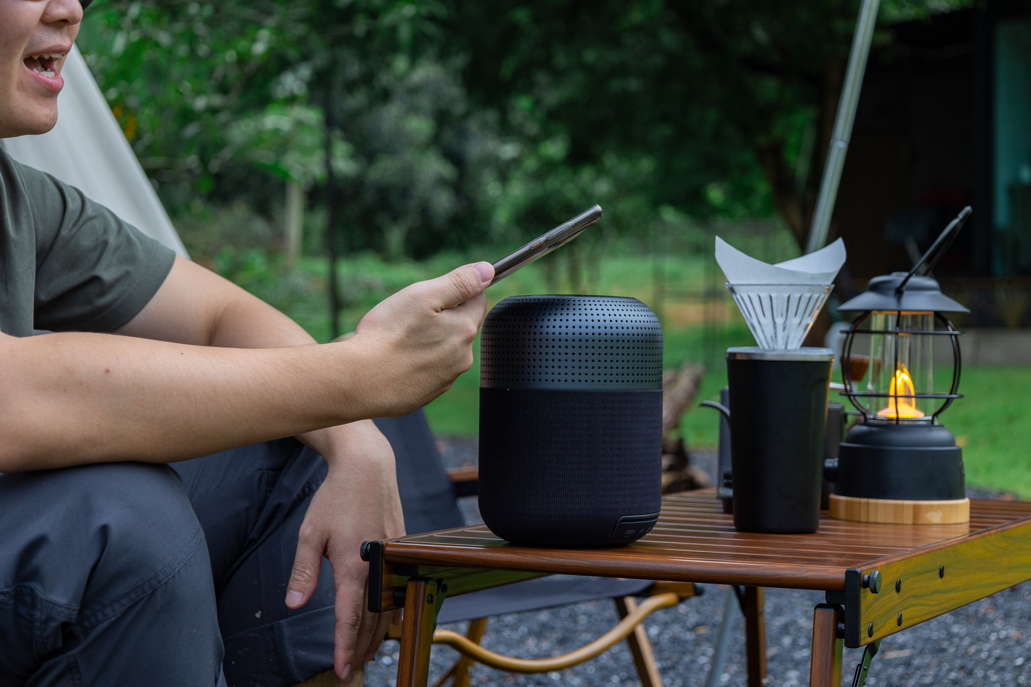 Man connecting to bluetooth to listen to relaxing music outside in backyard.