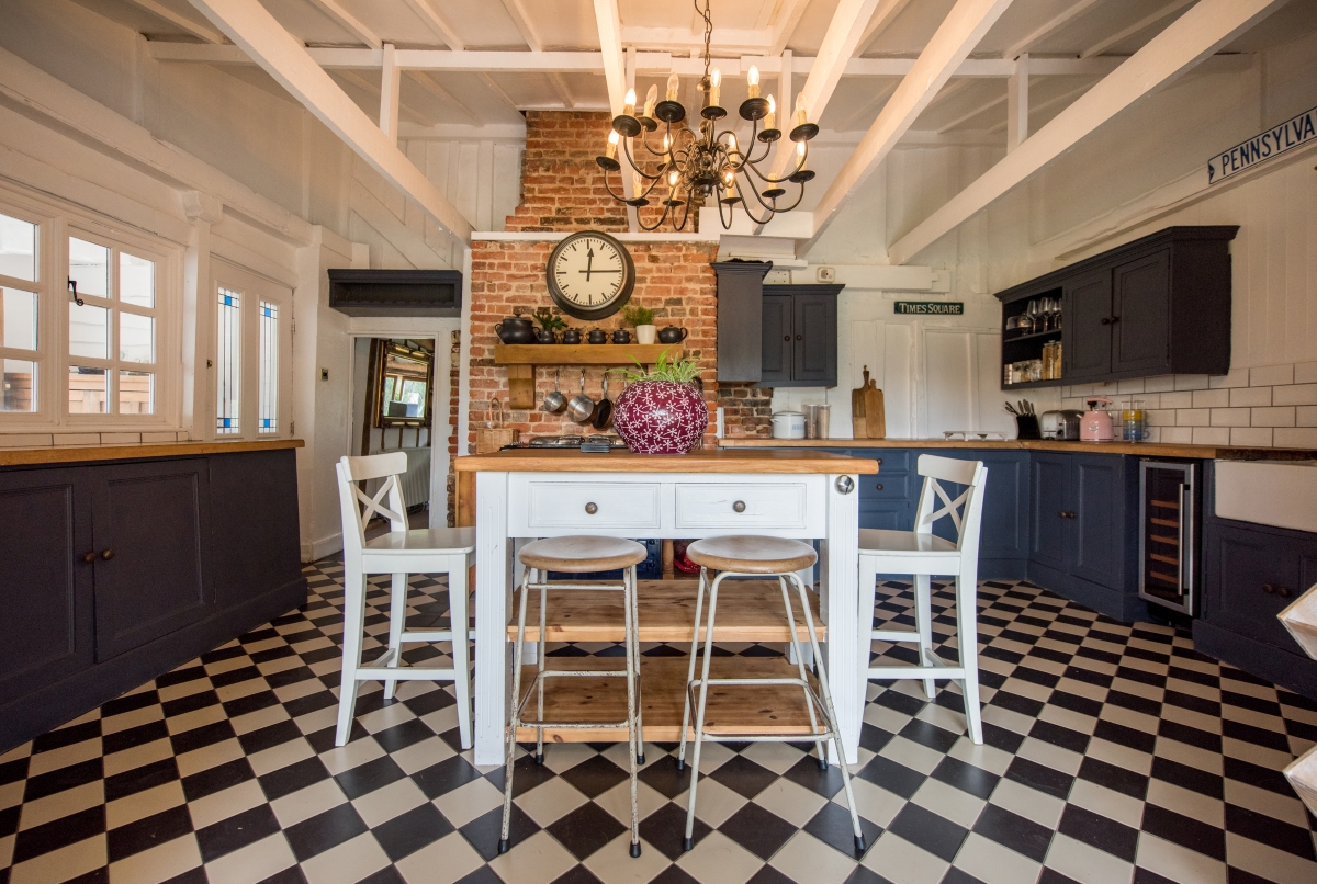 Large open kitchen with checkered flooring.