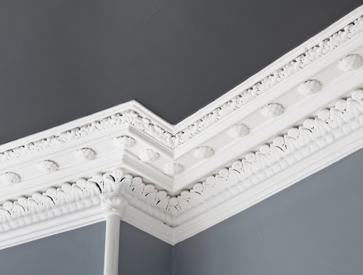 White crown molding along the ceiling with an elaborate design.