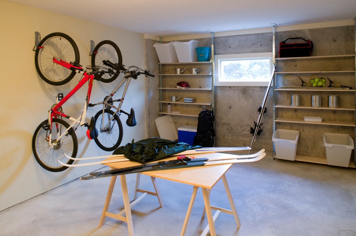 Basement with sports equipment and shelving.