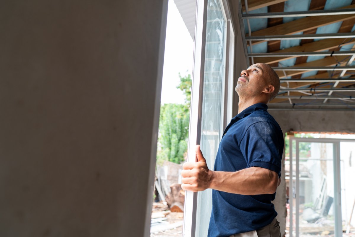 Construction worker installing a new window.