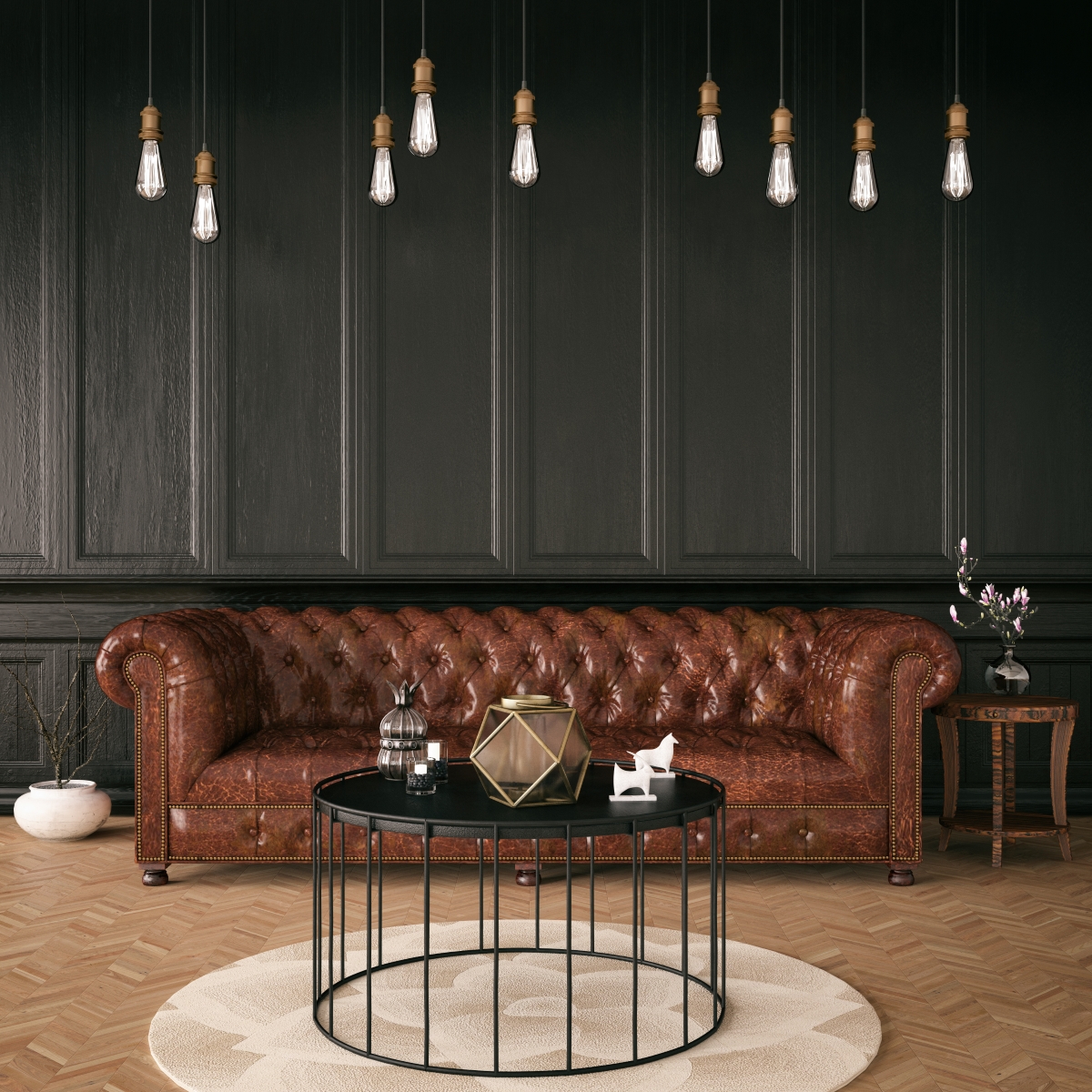 A leather couch in front of a dark colored wall.