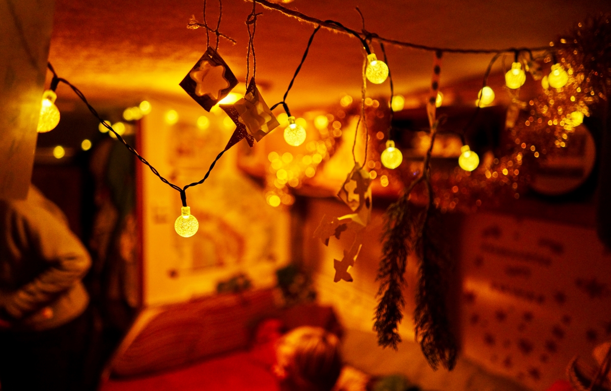 Cozy, warm, string lights are hung in the basement.