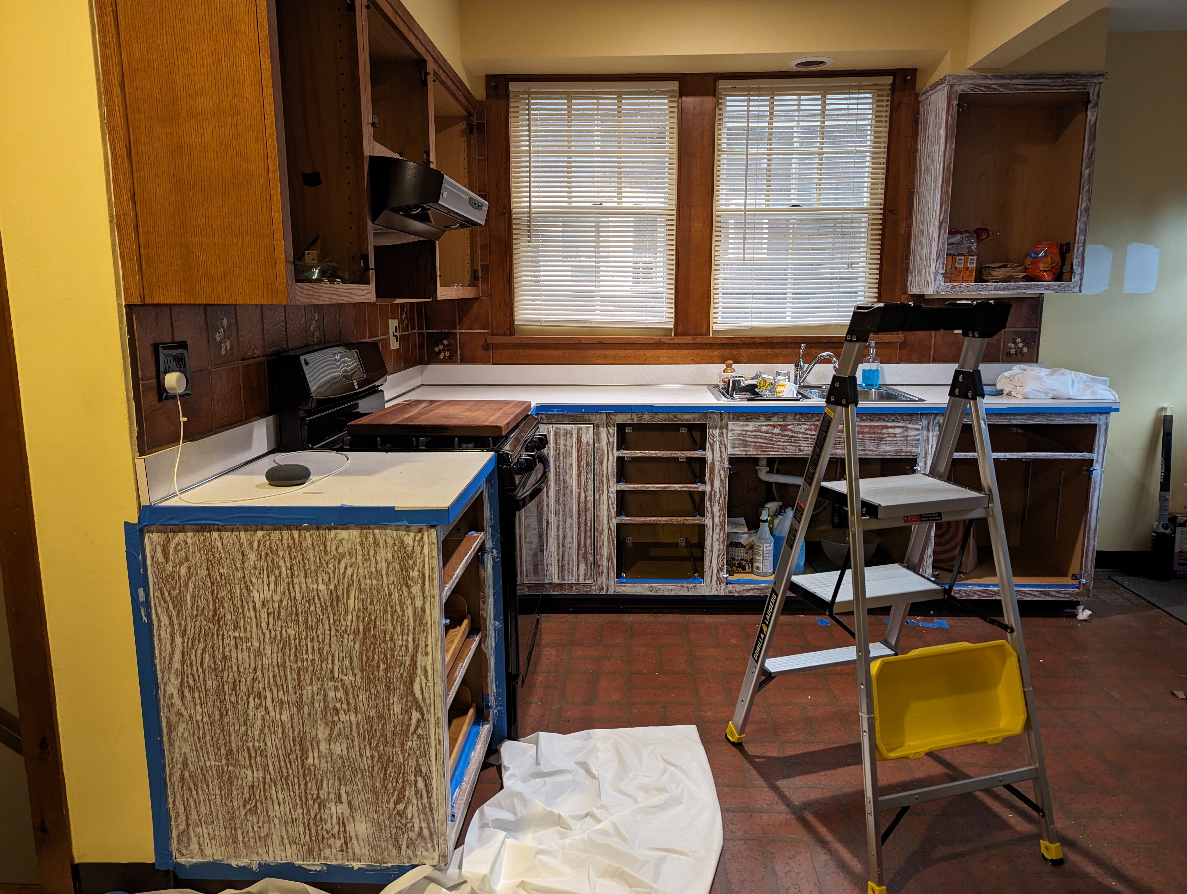 Oak kitchen cabinets prepped for painting in DIY renovation